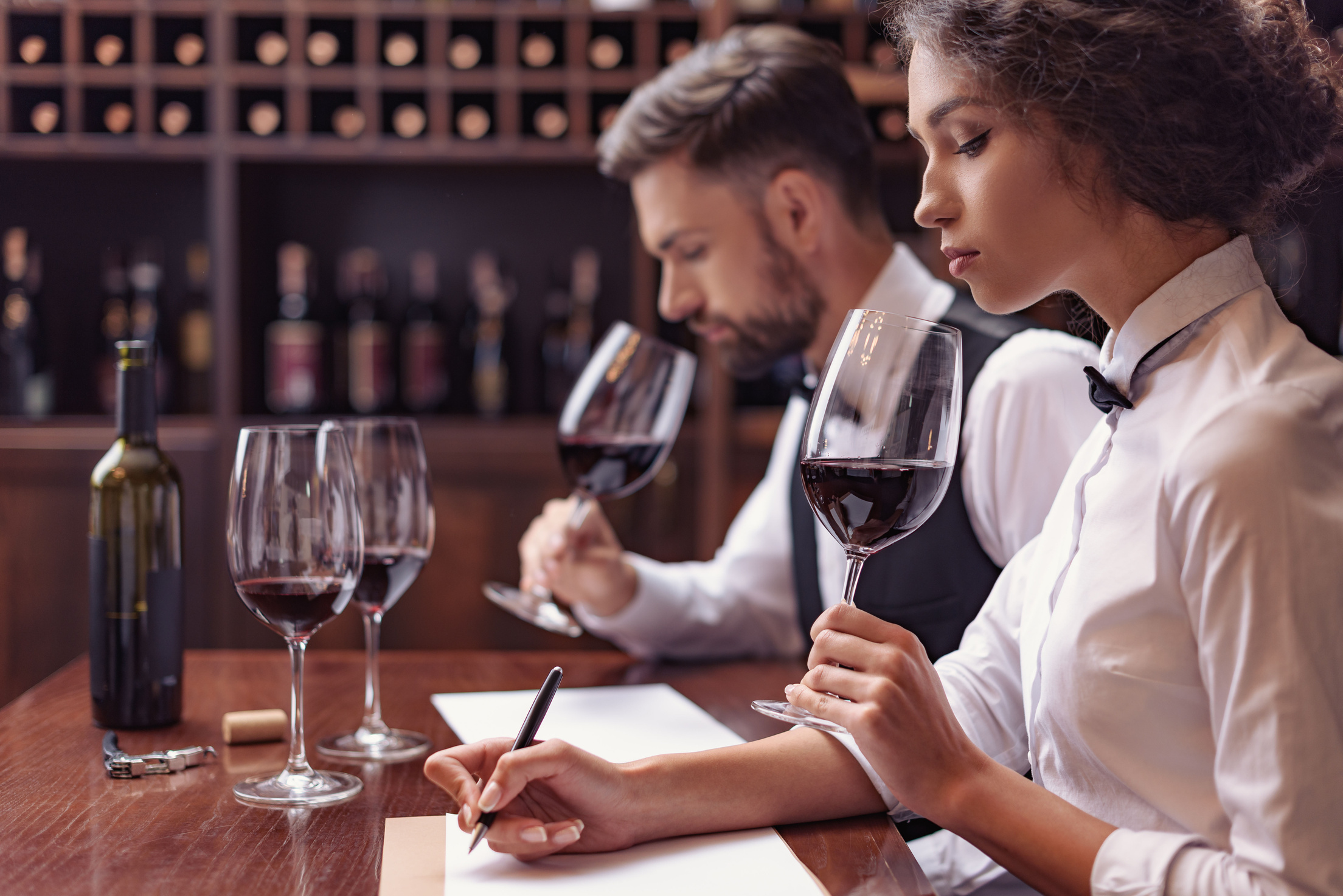 Sommeliers tasting wine in cellar